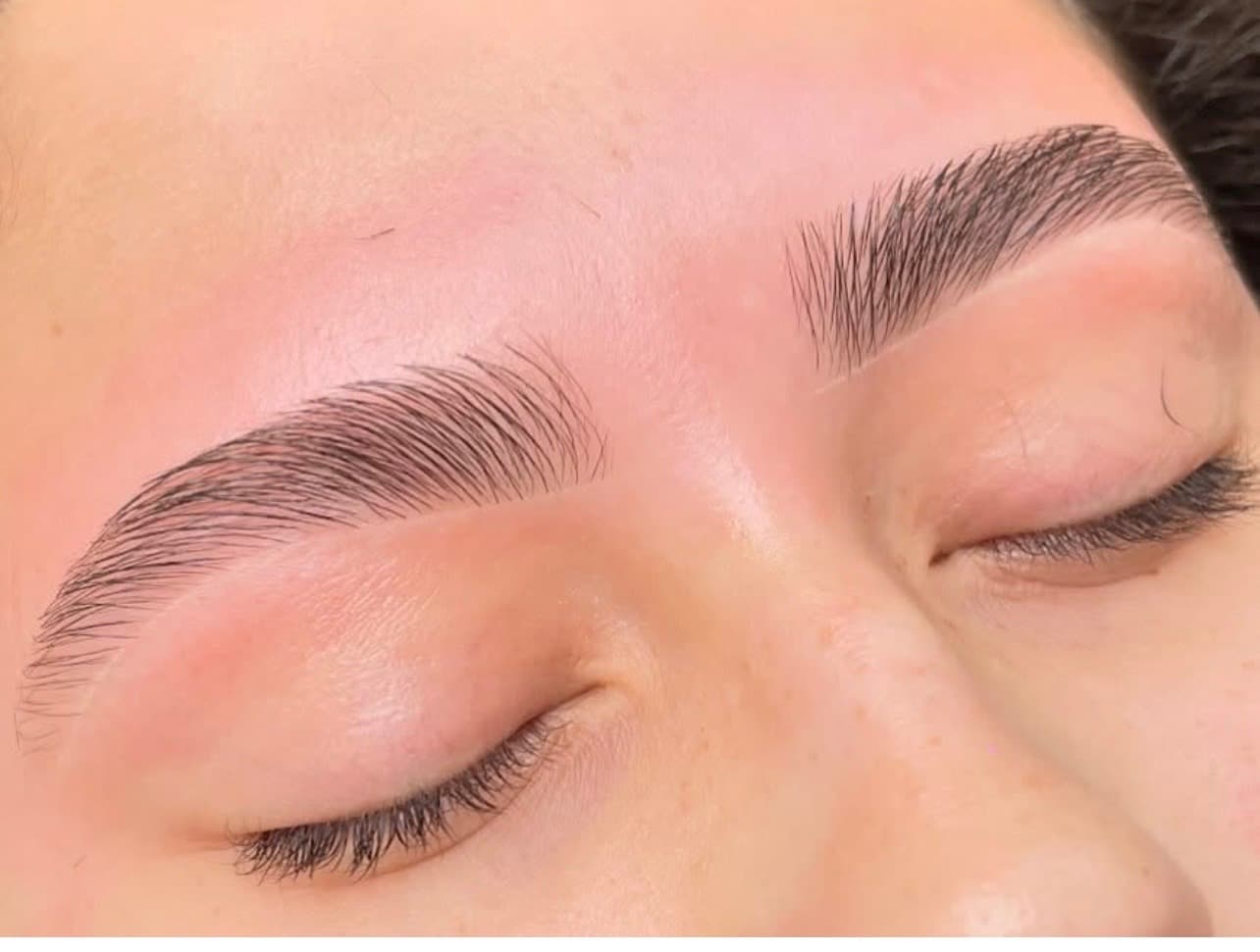 Close-up of cleanly defined brows following a wax service